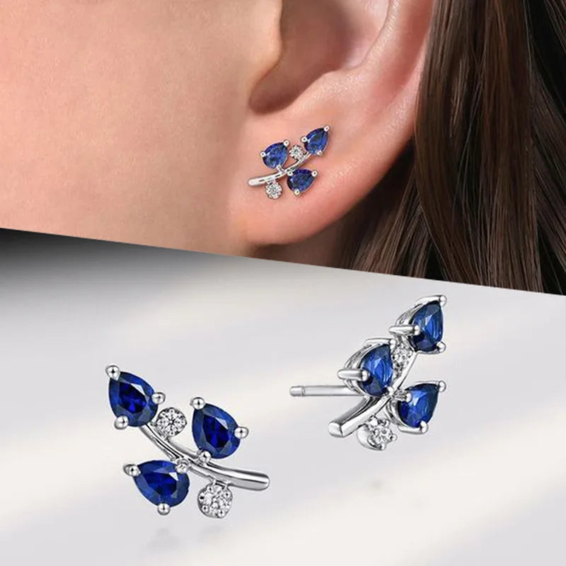 Elegant blue cubic zirconia hoop earrings worn on an ear, showcasing trendy design for wedding and anniversary gifts.